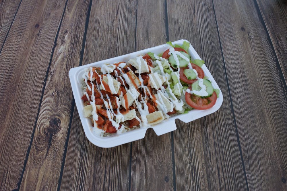 Chicken and rice halal platter with white and hot sauce